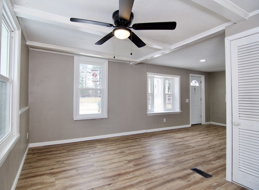 511 Parker Street Springfield, MA 01129 - Photo 7 of 41 a view of an empty room with wooden floor and a window