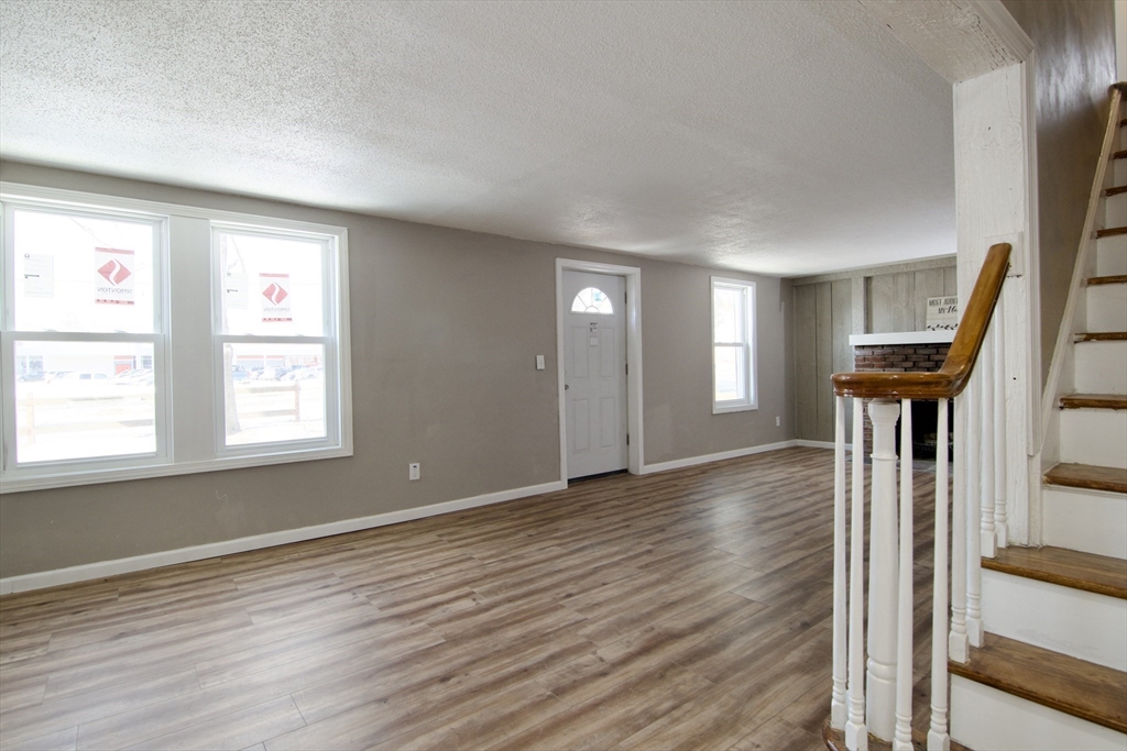 511 Parker Street Springfield, MA 01129 - Photo 9 of 41 a view of an empty room with a window and wooden floor