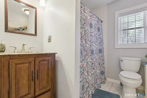 a white toilet sitting next to a bathroom sink