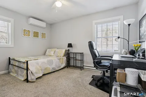 a bedroom with furniture and a window