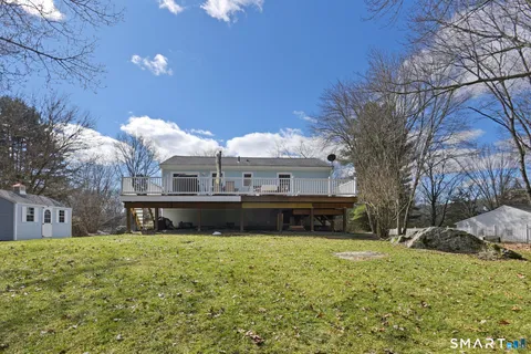 a view of a house with a yard and sitting area
