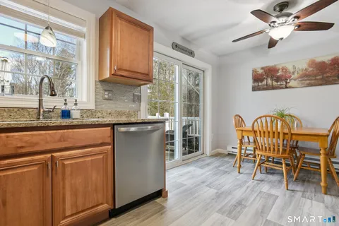 a kitchen with stainless steel appliances granite countertop a microwave a stove and a wooden floors