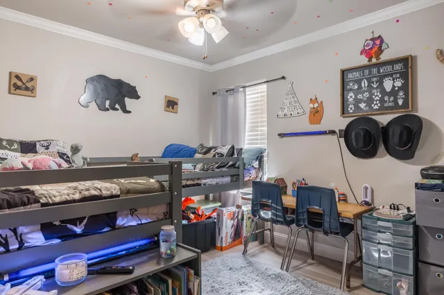 a living room with lots of furniture and baby bed