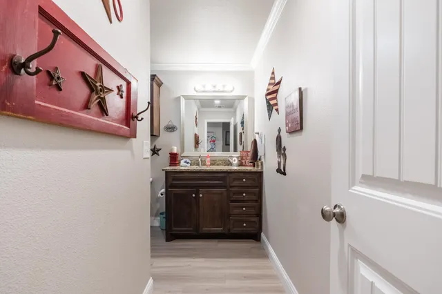 a bathroom with a sink vanity and a mirror