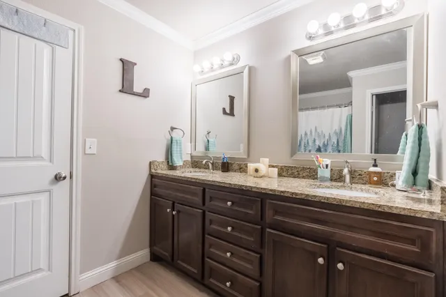 a spacious bathroom with a granite countertop sink a mirror and a