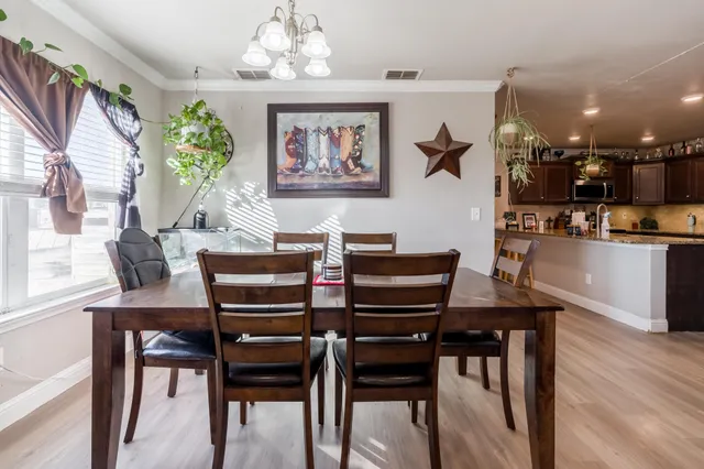 a view of a dining room with furniture and wooden floor