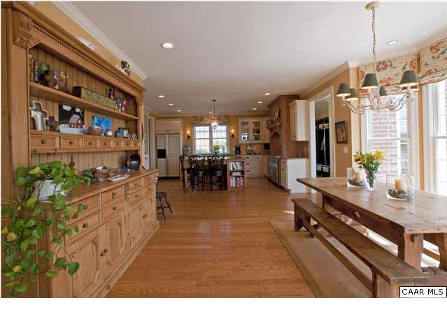 3505 Rocks Mill Lane Charlottesville, VA 22903 - Photo 13 of 33 a living room with stainless steel appliances kitchen island granite countertop a large kitchen island a stove a sink a dining table and chairs with the wooden floor