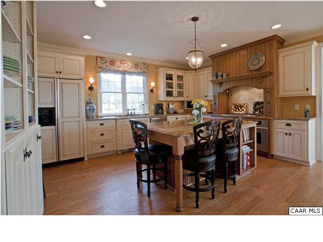 3505 Rocks Mill Lane Charlottesville, VA 22903 - Photo 15 of 33 a kitchen with stainless steel appliances kitchen island granite countertop a dining table chairs and white cabinets