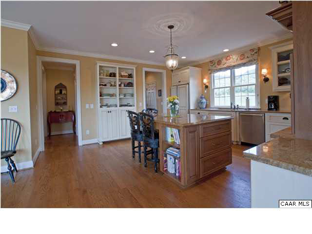3505 Rocks Mill Lane Charlottesville, VA 22903 - Photo 16 of 33 a kitchen with stainless steel appliances granite countertop a table chairs and a refrigerator