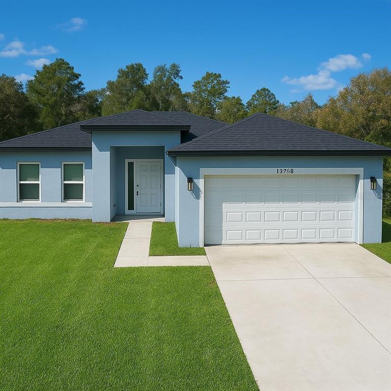 13739 Southwest 43rd Circle Ocala, FL 34473 - Photo 1 of 1 a front view of a house with a yard and garage