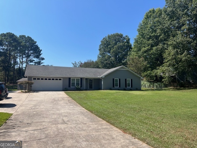 a front view of a house with a yard and trees