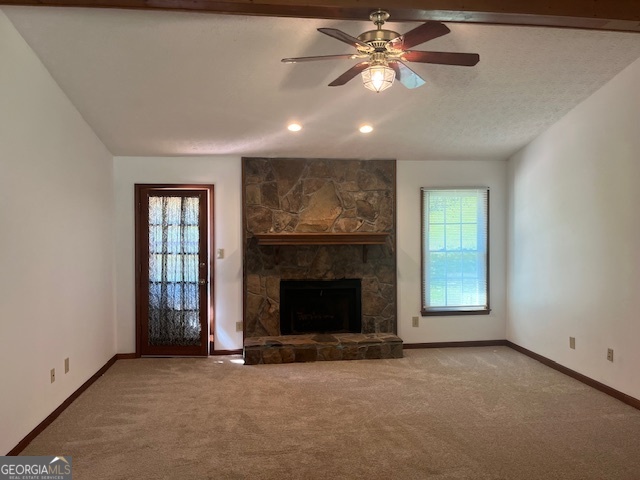 155 Hilo Road Fayetteville, GA 30215 - Photo 2 of 15 an empty room with windows fireplace and fan
