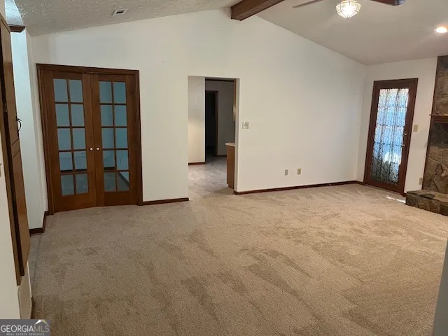 a view of an empty room with closet and wooden floor