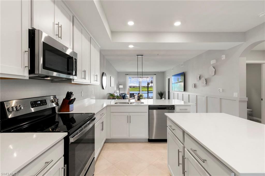 a kitchen with stainless steel appliances a sink microwave and stove