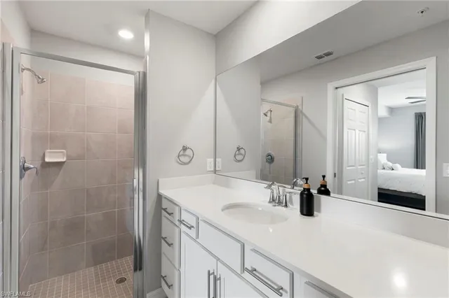 a bathroom with a shower sink and mirror