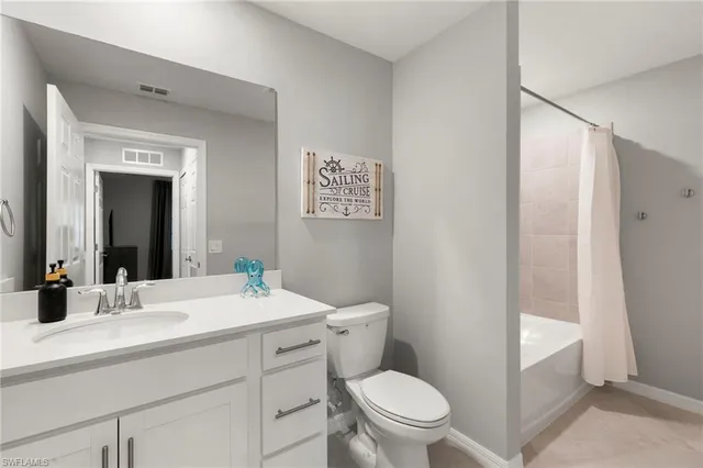 a bathroom with a sink a toilet a mirror and shower