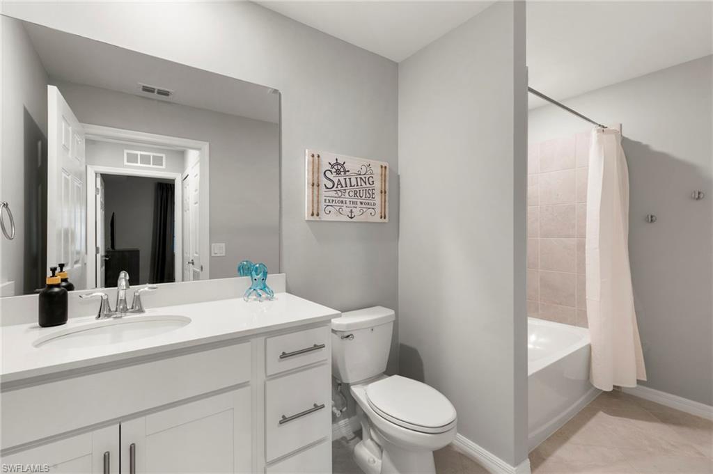 43993 Boardwalk Loop, Unit 1914 Punta Gorda, FL 33982 - Photo 19 of 36 Full bathroom with vanity, shower / bathtub combination with curtain, and light tile patterned floors