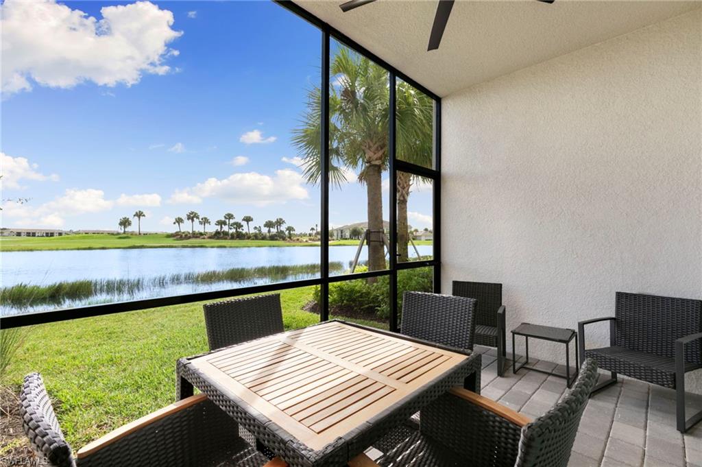 43993 Boardwalk Loop, Unit 1914 Punta Gorda, FL 33982 - Photo 23 of 36 Sunroom / solarium featuring outdoor dining space, a ceiling fan, and a water view