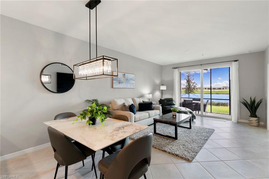 43993 Boardwalk Loop, Unit 1914 Punta Gorda, FL 33982 - Photo 6 of 36 Dining area with a water view, light tile patterned floors, and a chandelier