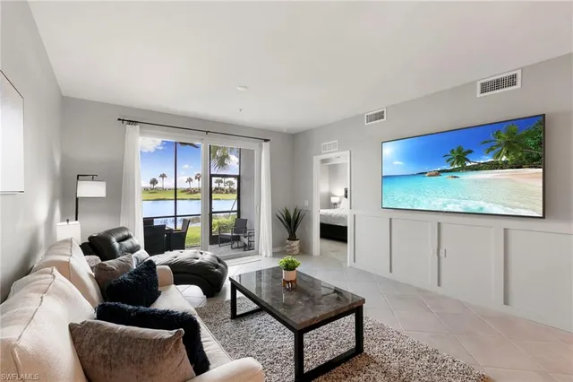 a living room with furniture a rug and a large window