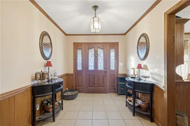 a view of hall way with furniture and a mirror