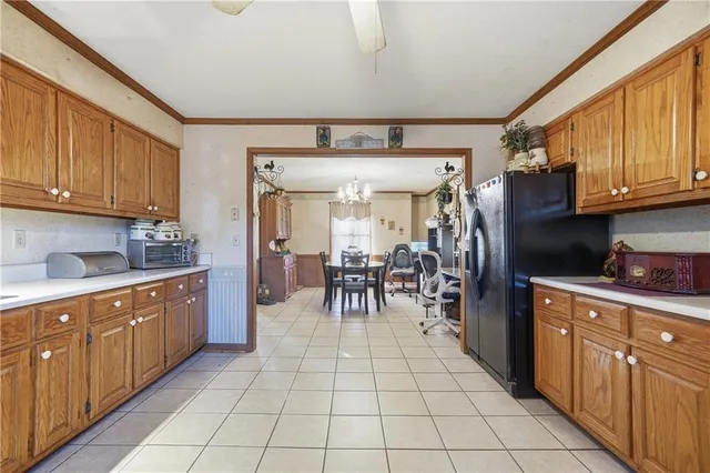 a kitchen with stainless steel appliances granite countertop a refrigerator and a sink