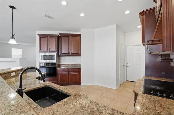 a kitchen with kitchen island a sink stove and refrigerator
