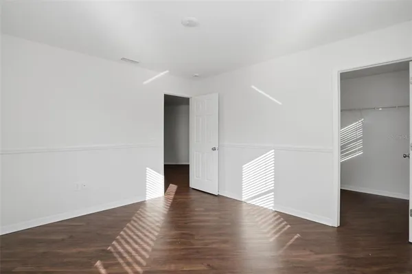 an empty room with wooden floor