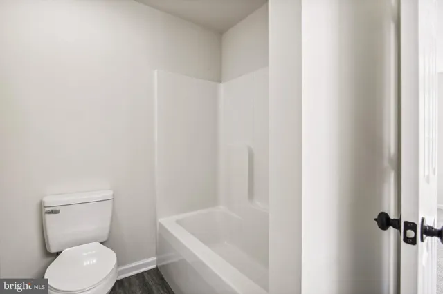 a white toilet sitting next to a white sink