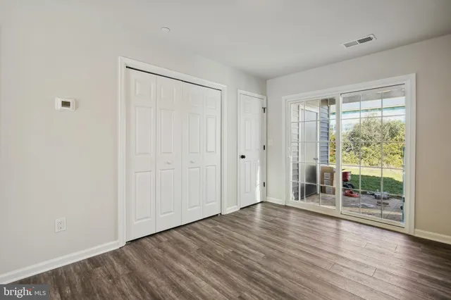 a view of wooden floor and windows in a room