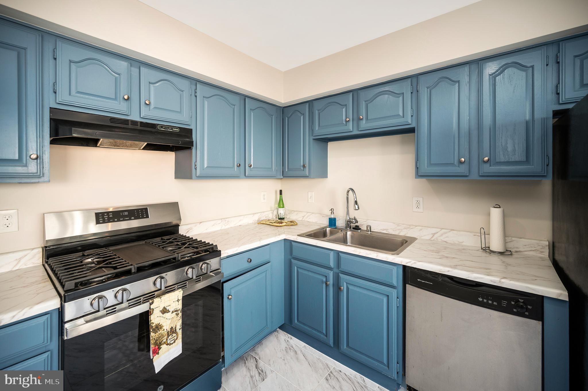 17950 Milroy Drive Dumfries, VA 22026 - Photo 14 of 42 a kitchen with sink cabinets and stainless steel appliances