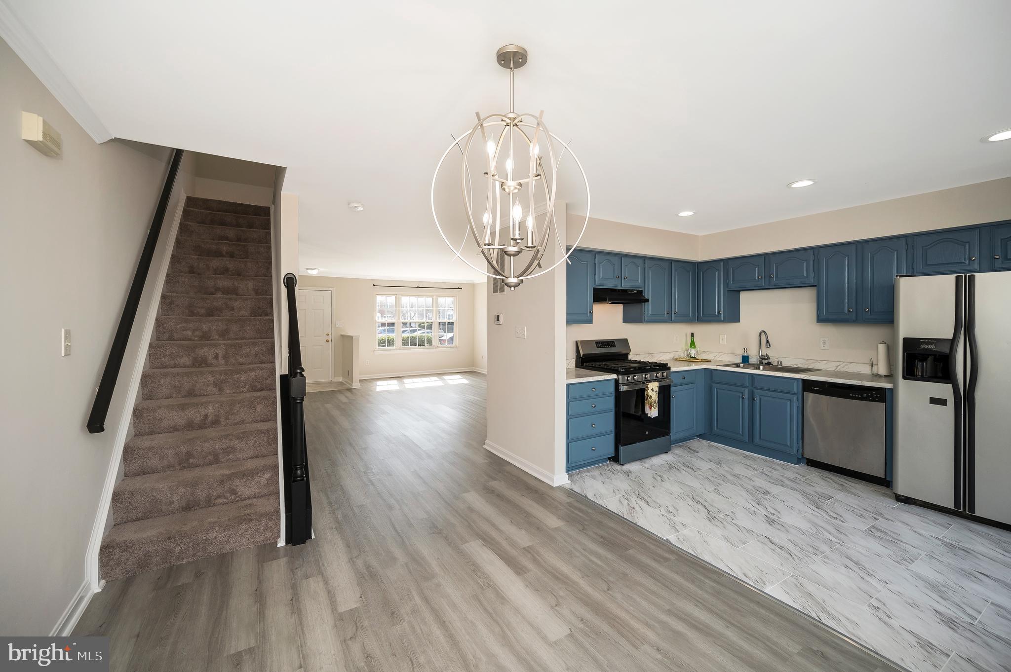 17950 Milroy Drive Dumfries, VA 22026 - Photo 20 of 42 a kitchen with stainless steel appliances granite countertop a refrigerator a stove and a wooden floors
