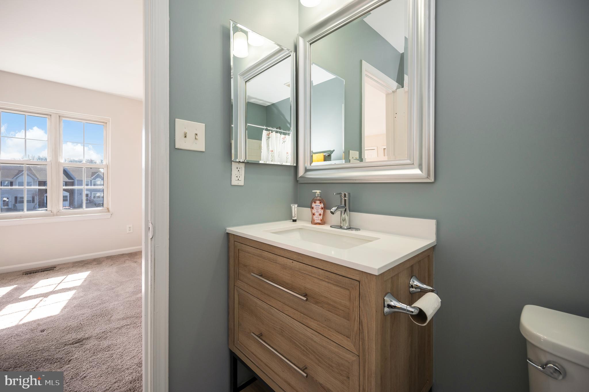 17950 Milroy Drive Dumfries, VA 22026 - Photo 25 of 42 a bathroom with a sink and a mirror