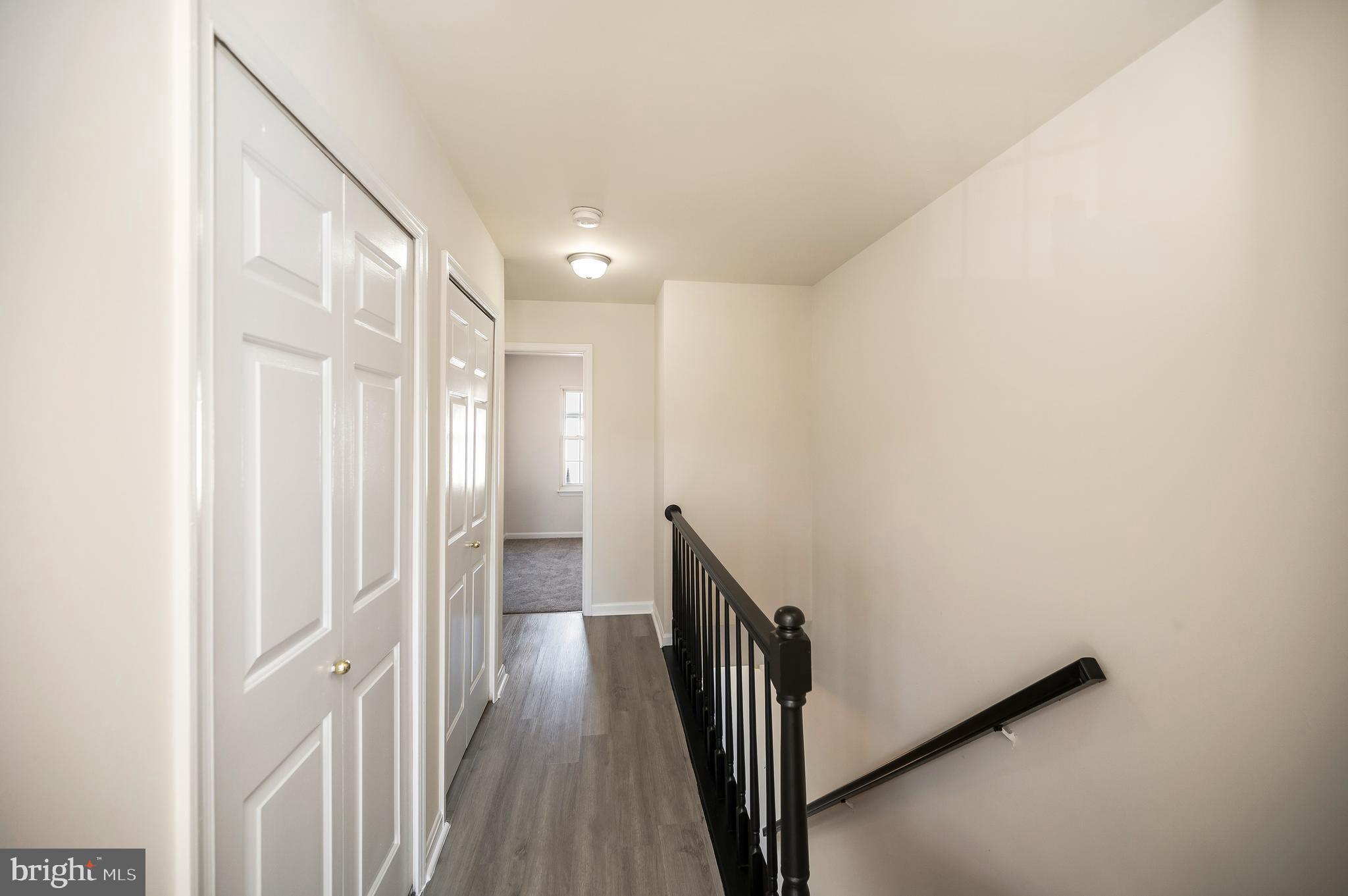 17950 Milroy Drive Dumfries, VA 22026 - Photo 26 of 42 a view of a hallway with wooden floor