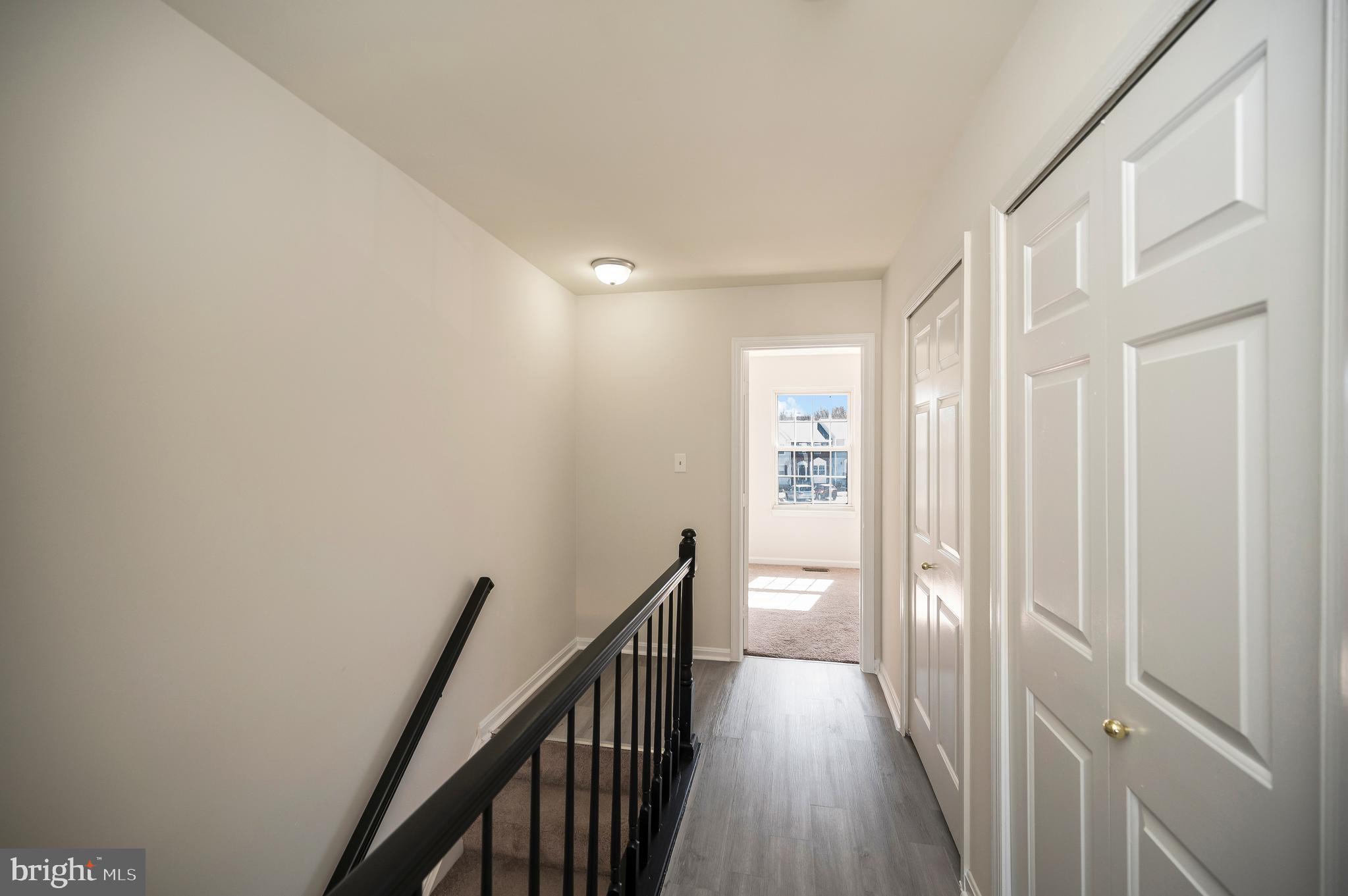 17950 Milroy Drive Dumfries, VA 22026 - Photo 27 of 42 a view of a hallway with wooden floor and staircase