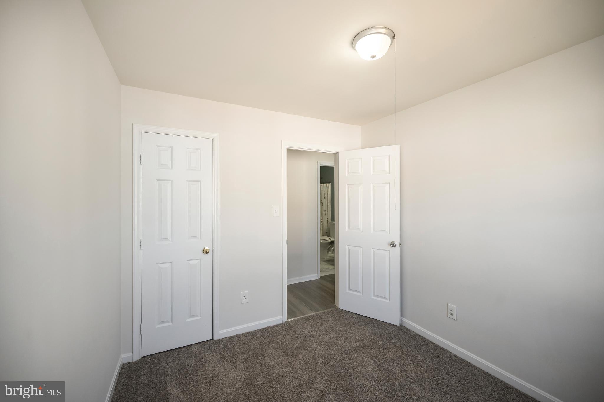 17950 Milroy Drive Dumfries, VA 22026 - Photo 32 of 42 an empty room with closet and a bathroom