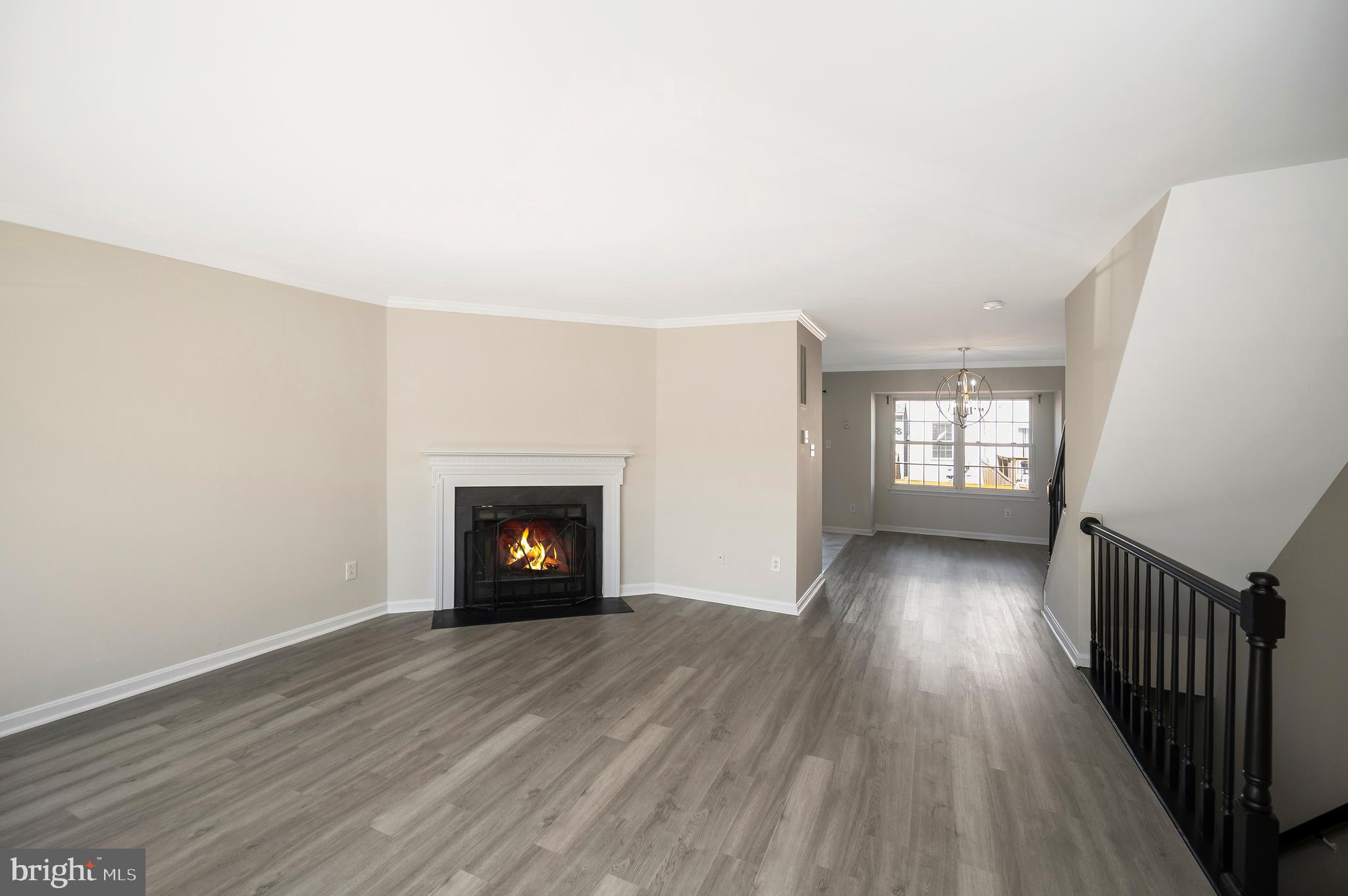 17950 Milroy Drive Dumfries, VA 22026 - Photo 6 of 42 wooden floor fireplace and windows in an empty room