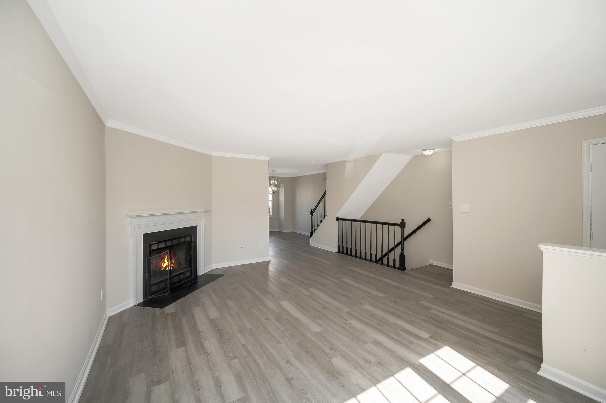 17950 Milroy Drive Dumfries, VA 22026 - Photo 7 of 42 a view of a livingroom with wooden floor and a fireplace