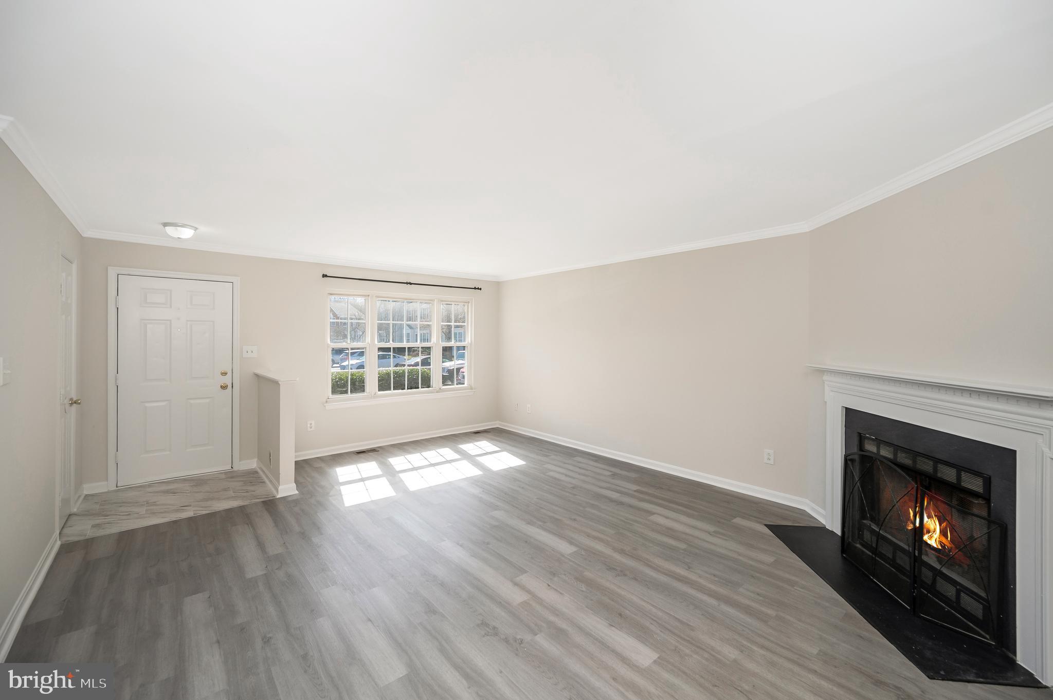 17950 Milroy Drive Dumfries, VA 22026 - Photo 8 of 42 a view of an empty room with wooden floor fireplace and a window