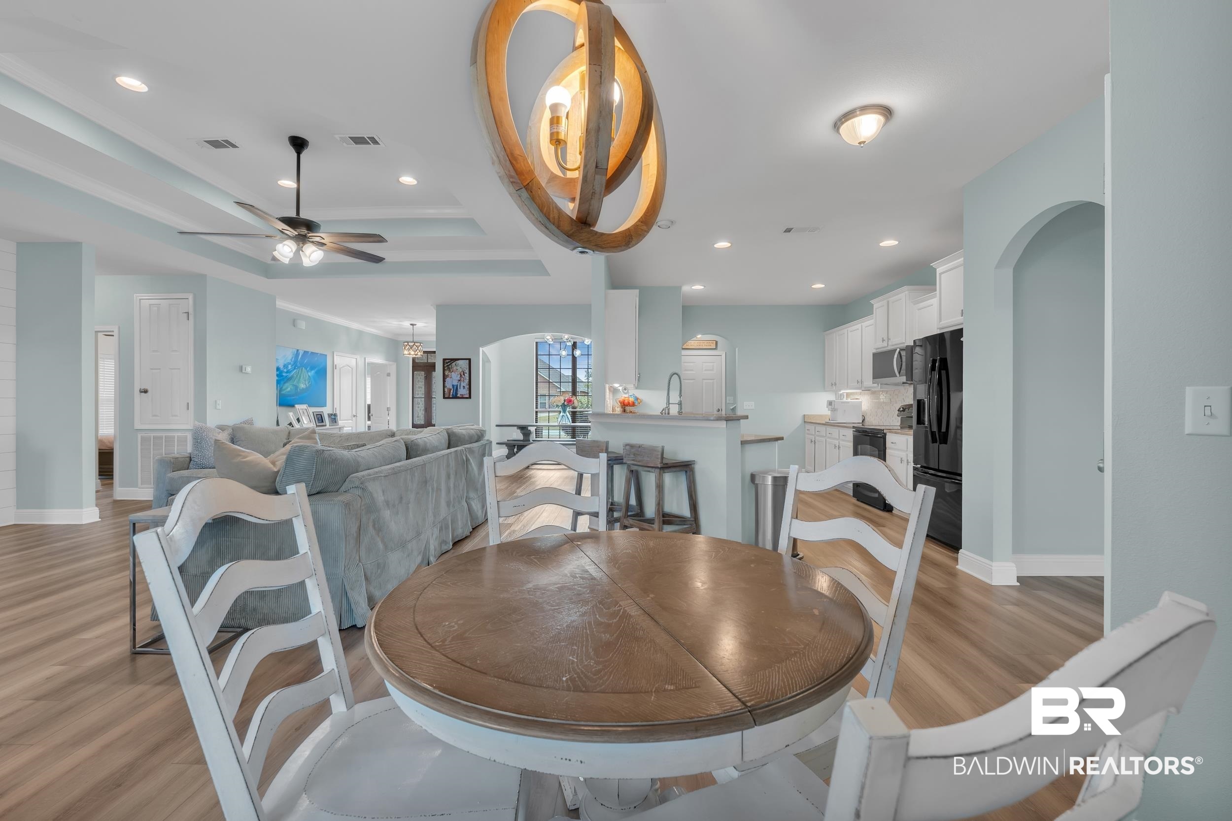 7109 Rocky Rd Loop Gulf Shores, AL 36542 - Photo 13 of 30 Dining area with a ceiling fan, light wood-style floors, visible vents, and baseboards