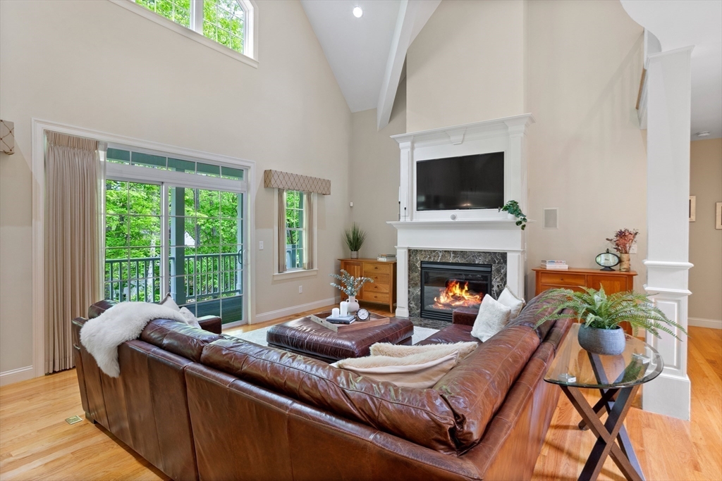 247 Whiley Road Groton, MA 01450 - Photo 12 of 42 a living room with furniture and a fireplace