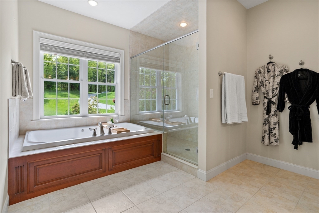 247 Whiley Road Groton, MA 01450 - Photo 16 of 42 a bathroom with a tub sink and mirror