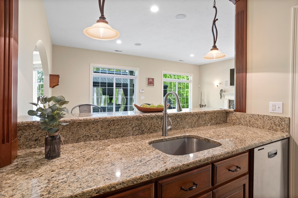 247 Whiley Road Groton, MA 01450 - Photo 26 of 42 a kitchen with a granite countertop sink and a window