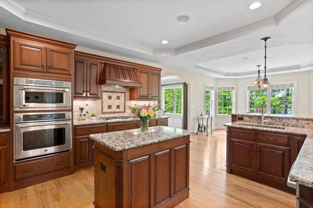 247 Whiley Road Groton, MA 01450 - Photo 3 of 42 a kitchen with stainless steel appliances granite countertop a stove a sink and a microwave
