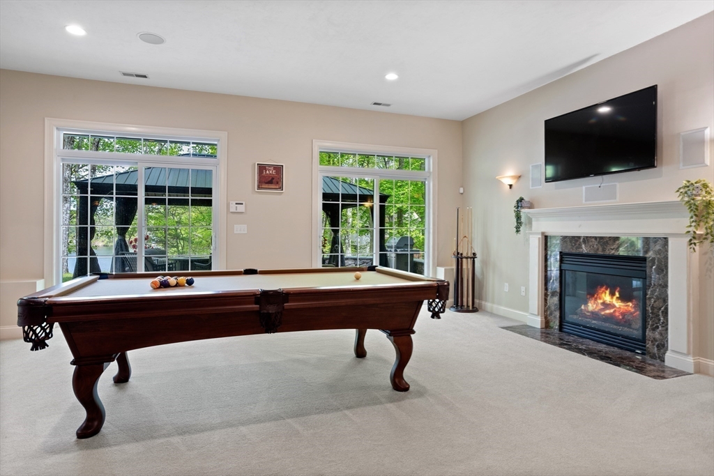 247 Whiley Road Groton, MA 01450 - Photo 33 of 42 a room with a large window and a fireplace