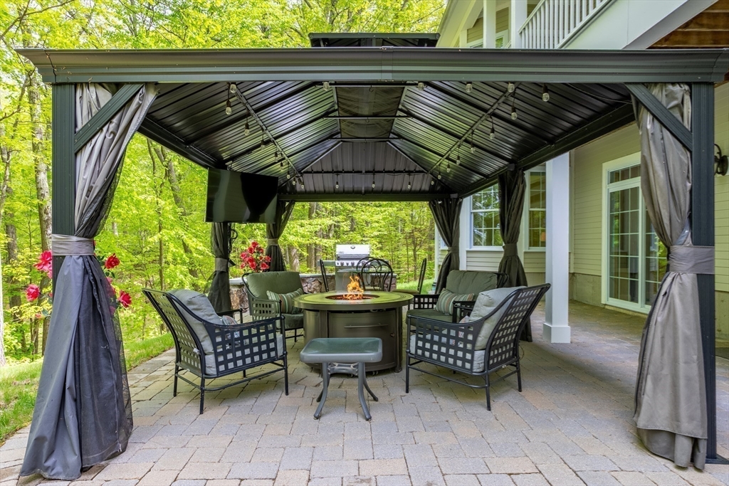 247 Whiley Road Groton, MA 01450 - Photo 36 of 42 a patio with a table and chairs