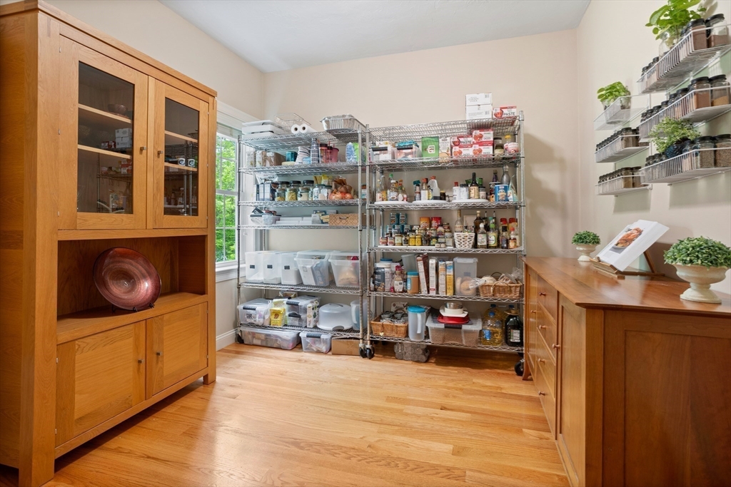 247 Whiley Road Groton, MA 01450 - Photo 7 of 42 a room with furniture and a book shelf