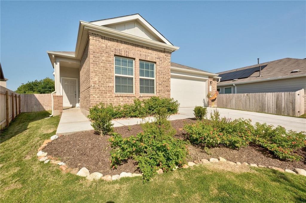 6813 Colorado Bluffs Road Austin, TX 78744 - Photo 1 of 20 View of front of house with brick siding, concrete driveway, and an attached garage