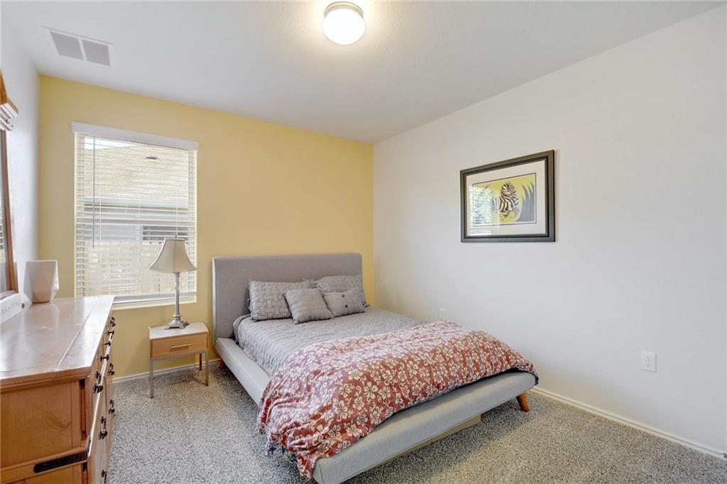 6813 Colorado Bluffs Road Austin, TX 78744 - Photo 12 of 20 Bedroom with baseboards and light carpet