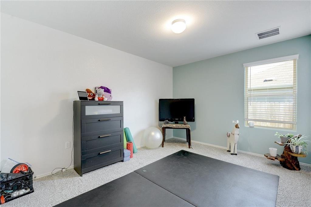 6813 Colorado Bluffs Road Austin, TX 78744 - Photo 13 of 20 Exercise room featuring carpet and baseboards